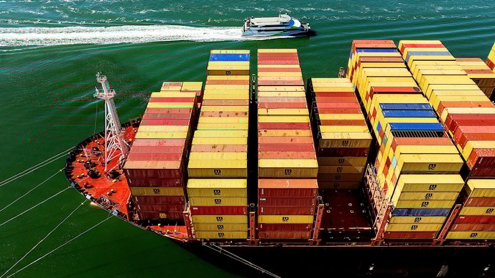 Cargo containers fill a ship at the Port of Oakland on Wednesday, Aug. 6, 2025, in Oakland, Calif. (AP Photo/Noah Berger)