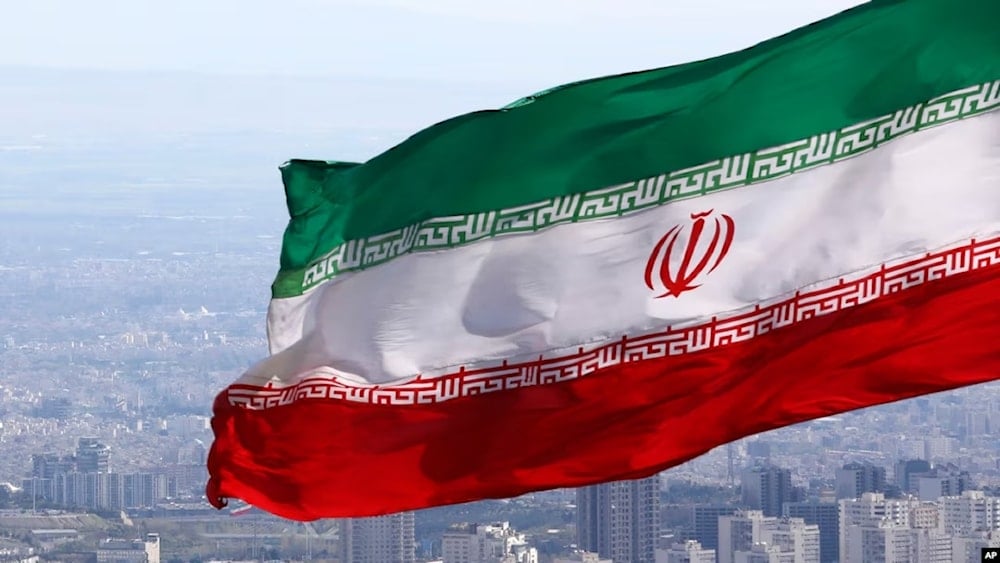 Iran's national flag waves in Tehran, Iran, March 31, 2020 (AP)