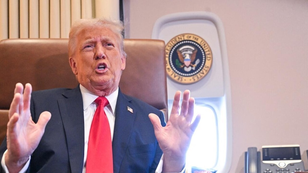 US President Donald Trump speaks to the press after signing a proclamation renaming the Gulf of Mexico as the Gulf of America aboard Air Force One, on Febrary 9, 2025. (Roberto Schmidt, AFP)