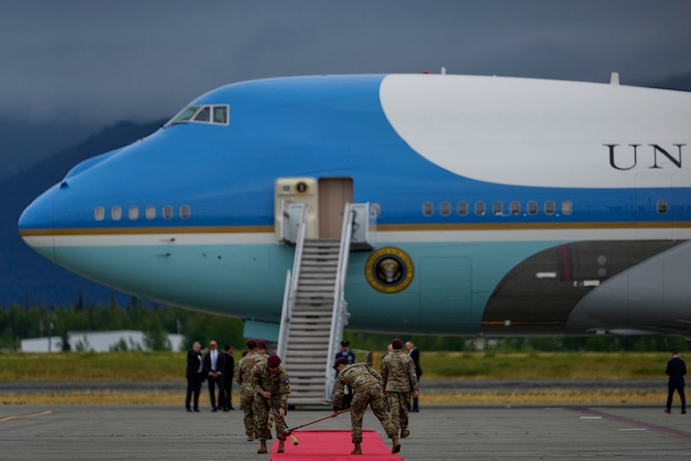 The red carpet is cleaned before President Donald Trump steps from Air Force One, Friday, August 15, 2025, at Joint Base Elmendorf-Richardson, Alaska, before meeting with Russia's President Vladimir Putin (AP)
