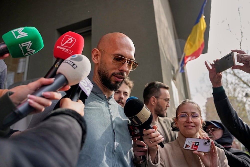 Andrew Tate speaks to media outside the Directorate for Investigating Organized Crime and Terrorism (DIICOT), in Bucharest, Romania, Tuesday, April 1, 2025. (AP Photo/Andreea Alexandru)