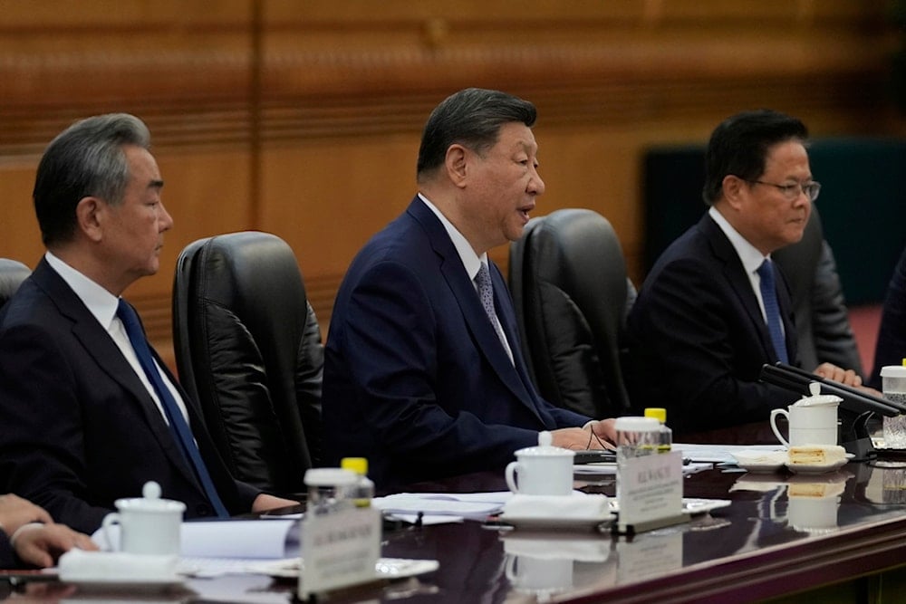 Chinese President Xi Jinping, center, speaks as foreign minister Wang Yi, left, looks during the opening remarks of the EU-China summit at the Great Hall of the People in Beijing, China, Thursday, July 24, 2025 (AP)