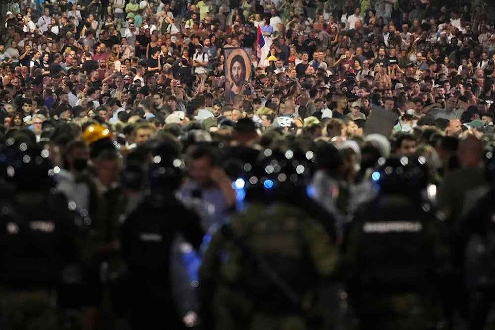 Serbian gendarmerie officers guard a street during an anti-government protest near the Serbian Progressive Party office in Belgrade, Serbia, Friday, Aug. 15, 2025 (AP)