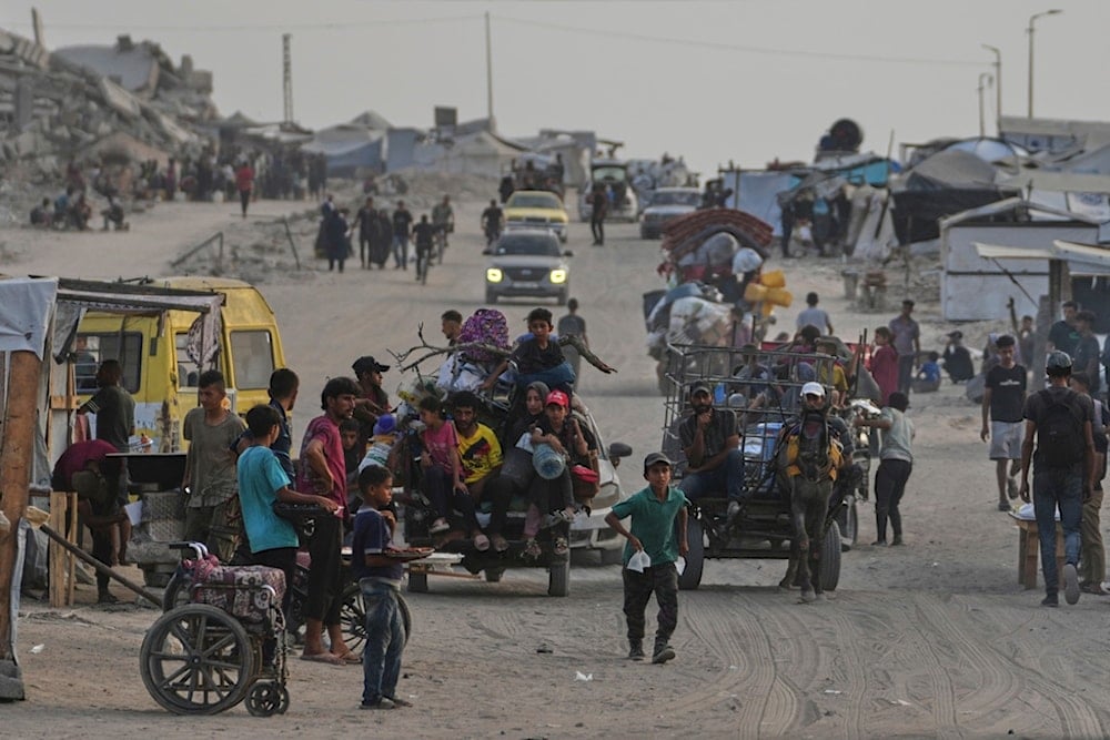Displaced Palestinians travel on carts and vehicles through a makeshift camp along the beach in Gaza City, Sunday, August 10, 2025 (AP)