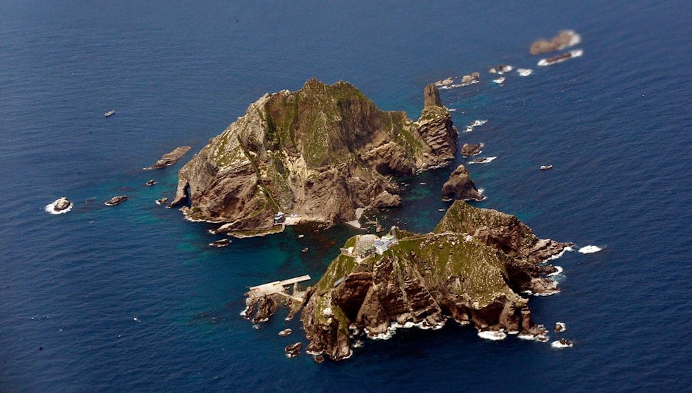 The disputed Dokdo islets, known as Takeshima in Japan, are observed during a Korean Air Airbus A380 demonstration flight Thursday, June 16, 2011. 