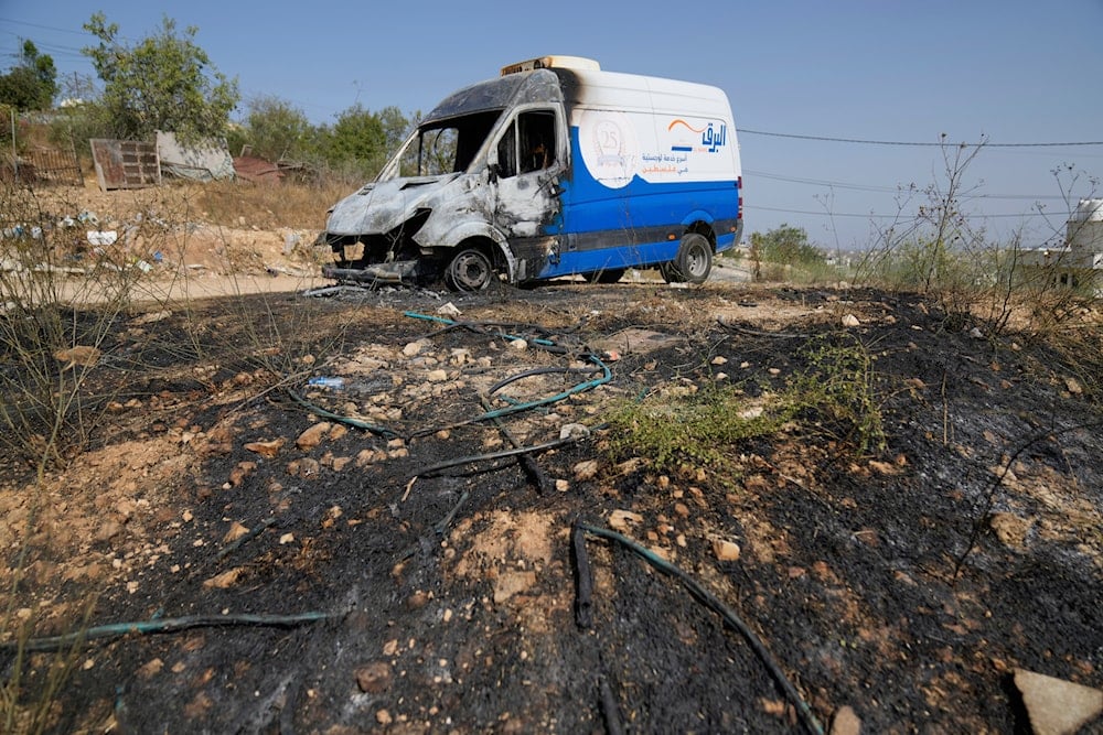 A vehicle is seen damaged after a rampage by Israeli settlers overnight, in the West Bank town of Atara, north of Ramallah Friday, Aug. 15, 2025 (AP)