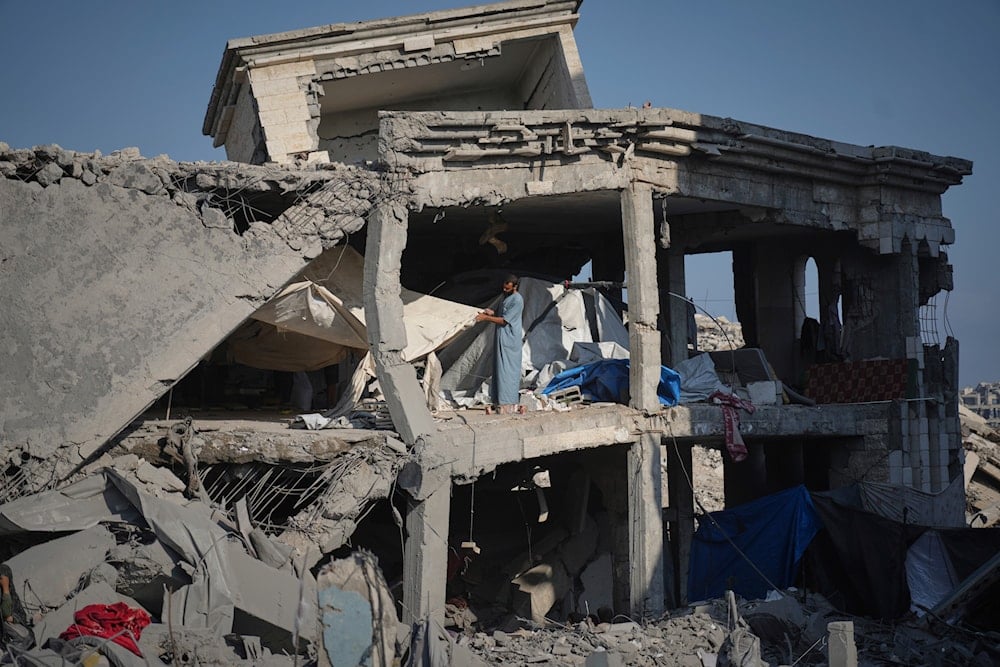 People inspect the damage at the Sheikh Radwan al-Taba UNRWA clinic following an Israeli army bombardment in Gaza City Wednesday, Aug. 6, 2025 (AP)