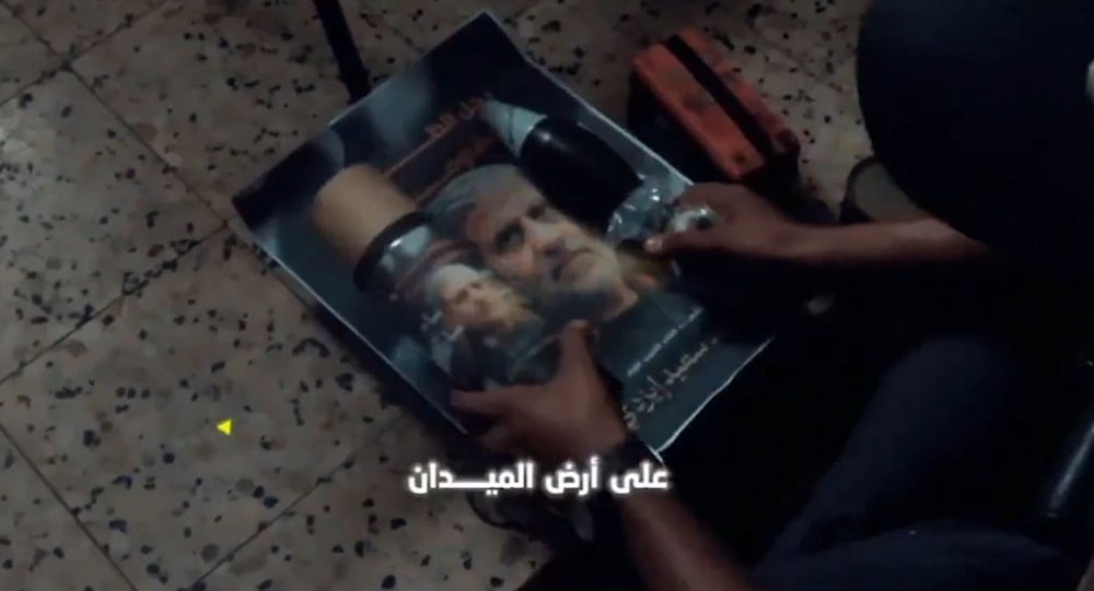 A Al-Quds Brigades fighters displays a picture of Martyr Hajj Ramadan next to a mortar round, Gaza, Occupied Palestine, August 17, 2025 (Al-Quds Brigades Military Media)