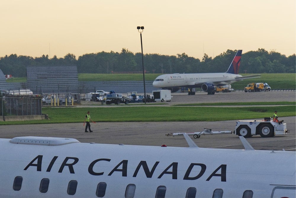 An Air Canada Express Bombardier CRJ900 operated by Jazz Aviation LP sits on the tarmac at Cincinnati/Northern Kentucky International Airport outside of Hebron, Ky., on August 15, 2025. (AP Photo/Jon Gambrell)