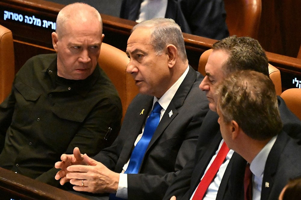 Israeli Prime Minister Benjamin Netanyahu, speaks to then Defense Minister Yoav Gallant, at the opening of a Knesset session in al-Quds, Monday, Oct. 28, 2024 (AP)