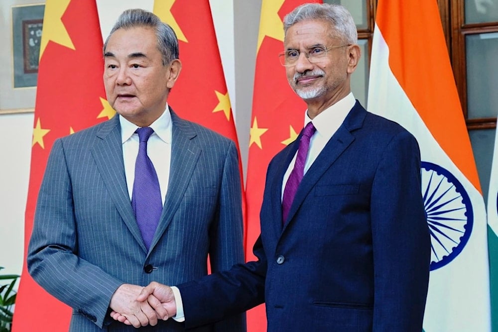 Indian Foreign Minister S. Jaishankar shakes hand with his Chinese counterpart Wang Yi, left, in New Delhi, India, Monday, Aug. 18, 2025. (Indian Foreign Ministry via AP)