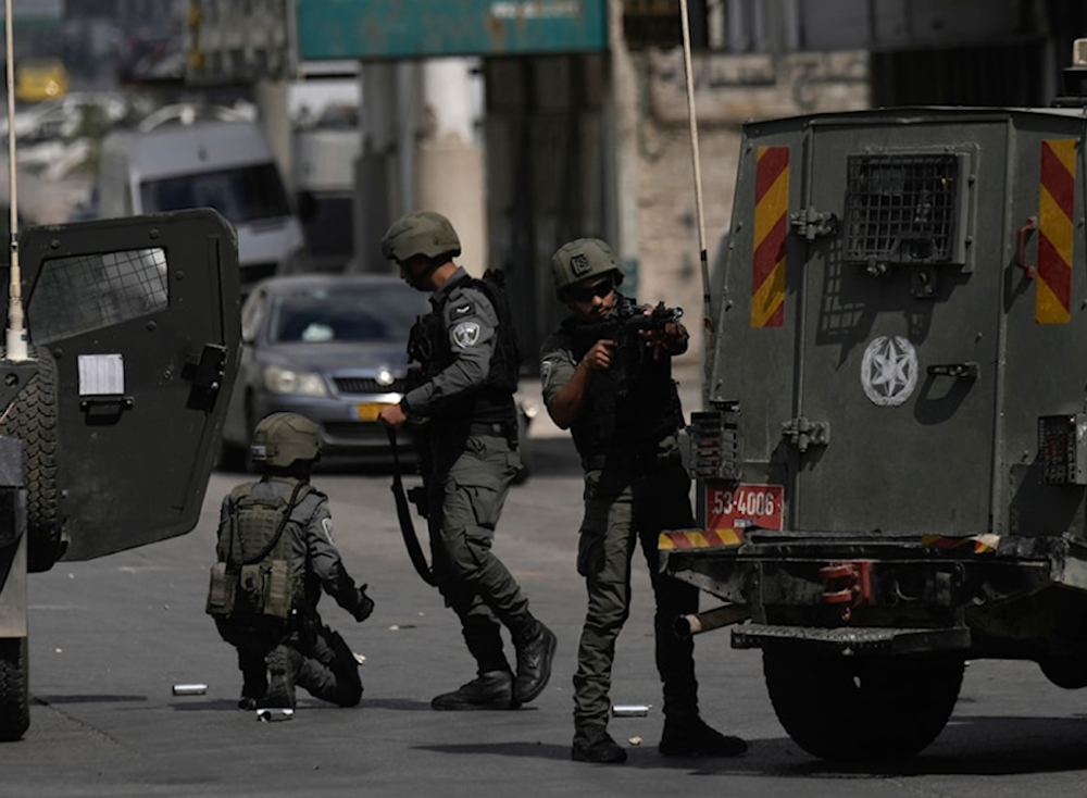 Israeli occupation forces (IOF) stand near their vehicles during a military incursion into the West Bank refugee camp of Balata occupied Palestine October 1, 2024. (AP)