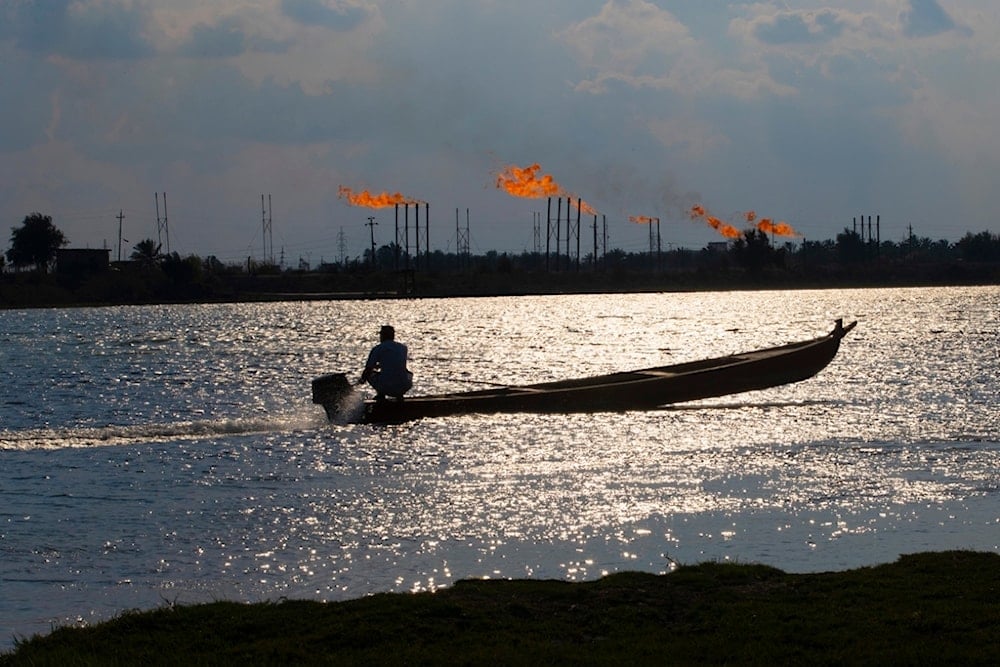 A man near the Nihran Bin Omar oil field north of Basra, Iraq, on Wednesday, March 22, 2023 (AP)