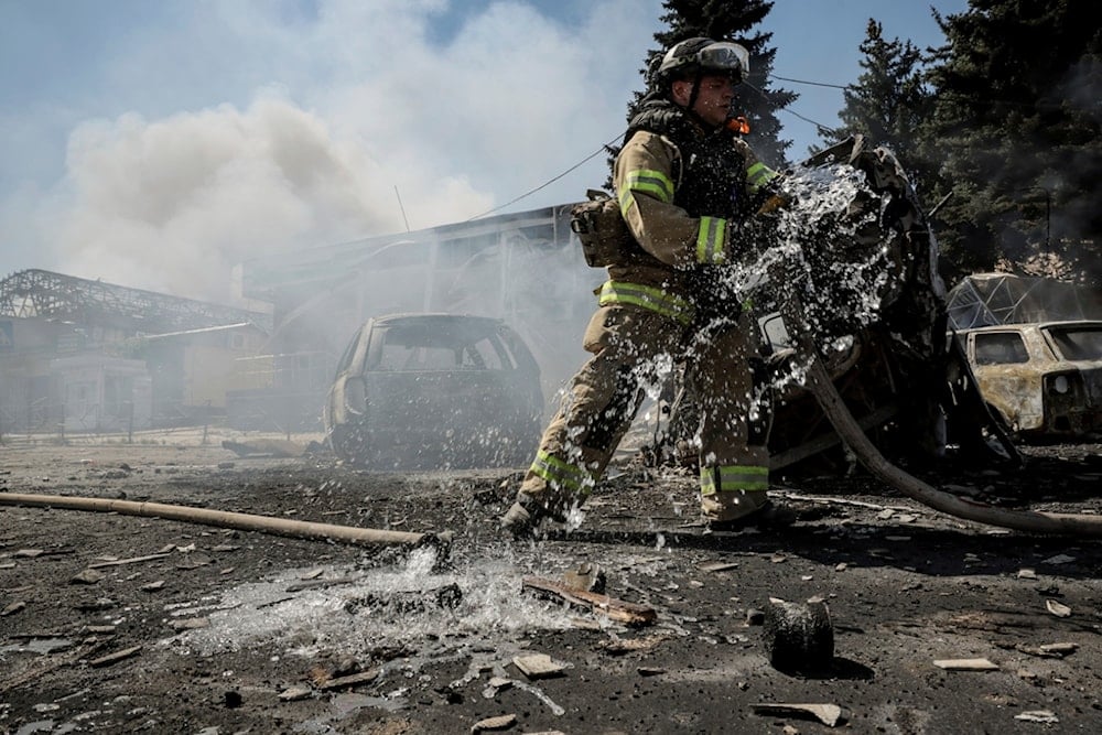 In this photo provided by Ukraine's 24th Mechanized Brigade press service, a firefighter puts out the fire after a Russian drone hit the market in the town of Druzhkivka, Donetsk region, Saturday, August 2, 2025 (AP)