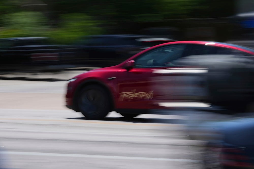 A driverless Tesla robotaxi, a ride-booking service, moves through traffic, on June 22, 2025, in Austin, Texas. (AP Photo/Eric Gay)