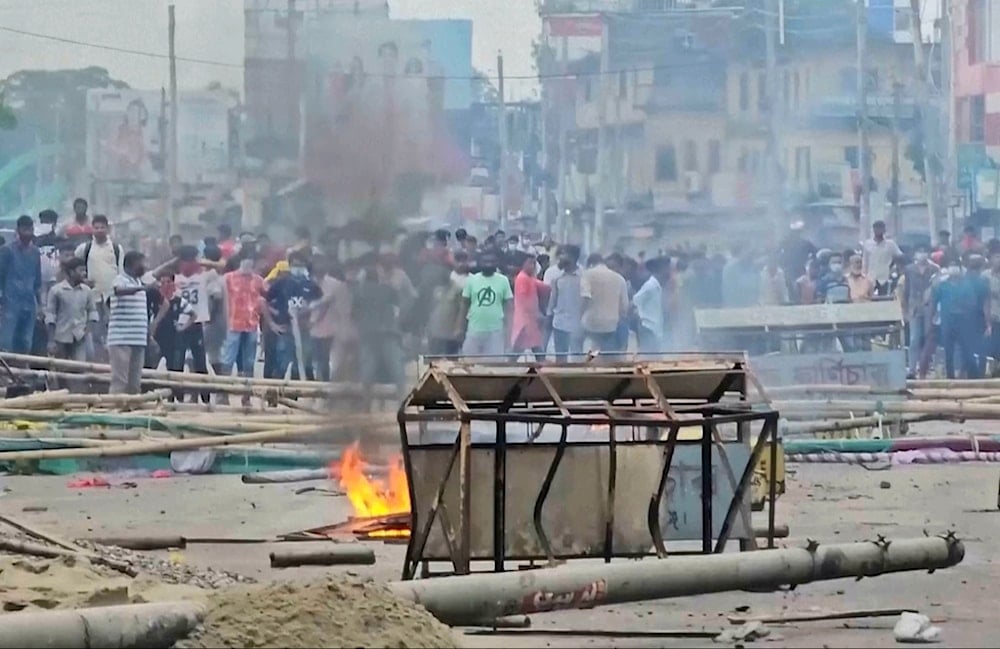 In this image made from a video, supporters of the ousted Prime Minister Sheikh Hasina clash with the police in Gopalganj, Bangladesh, Wednesday, July 16, 2025. (AP Photo)
