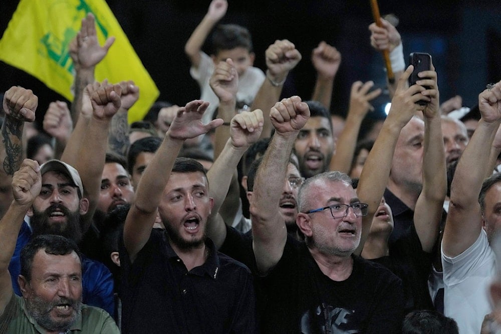 Hezbollah supporters shout slogans as Iranian Supreme National Security Council Secretary Ali Larijani arrives to visit the grave of former Hezbollah leader Sayyed Hassan Nasrallah in Beirut, Lebanon, Wednesday, August 13, 2025 (AP)