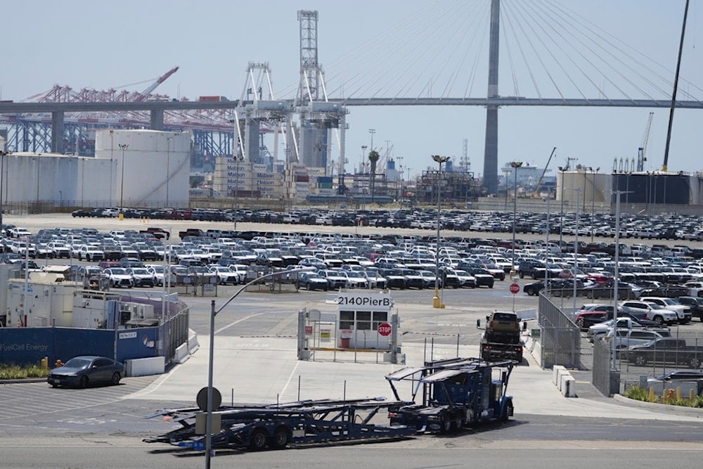 Rows of new vehicles sit near a port terminal at the Toyota Logistics Services Inc. lot on Wednesday, July 23, 2025, in Long Beach, Calif. (AP Photo/Damian Dovarganes)