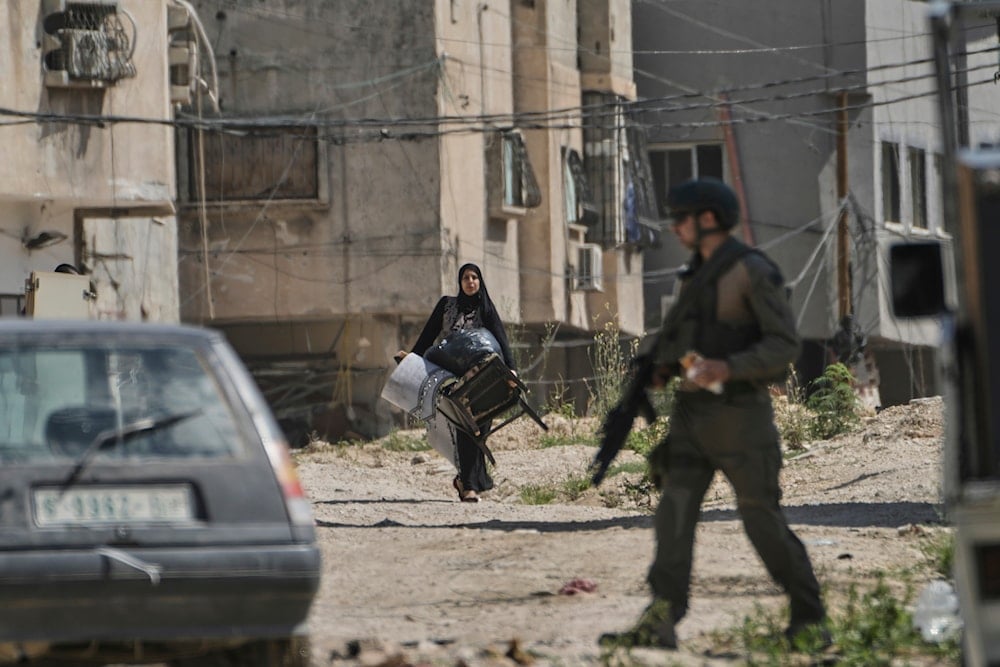 Palestinians gather their belongings as Israeli forces prepare to demolish homes in the Tulkarem refugee camp in the West Bank, on July 2, 2025. (AP Photo/Majdi Mohammed)