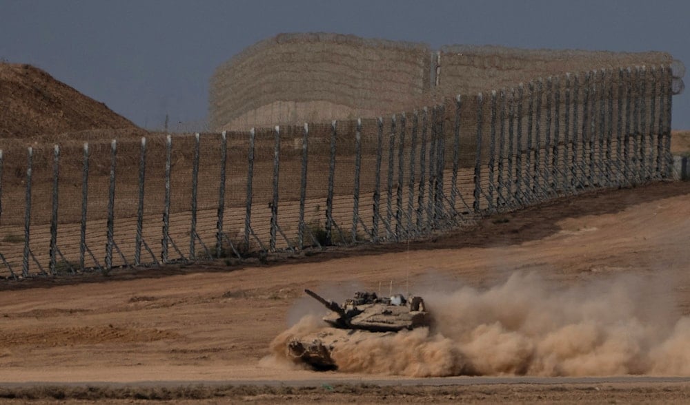 An Israeli tank moves through an area near the Gaza border, as seen from southern occupied Palestine, Wednesday, Aug. 20, 2025. (AP)