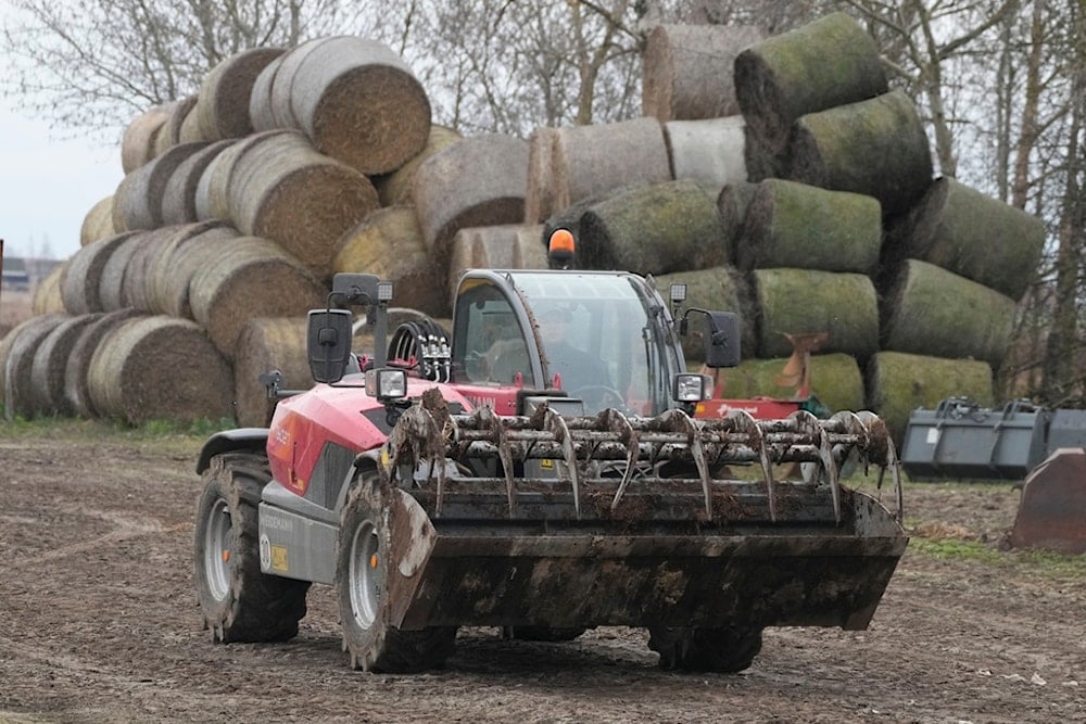 Piotr Korycki, a 34-year-old Polish farmer, drives farm equipment on his farm in Cywiny Wojskie, Poland, on Monday March 18, 2024. (AP)