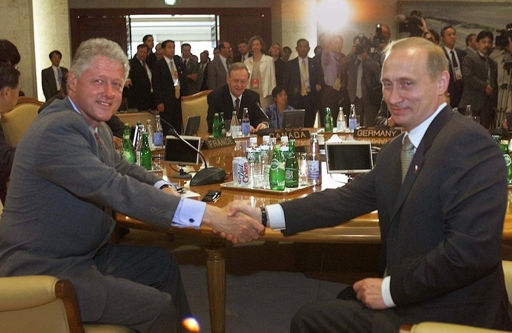 President Clinton, and Russian President Vladimir Putin shake hands before Group of Eight summit meeting in Nago, Okinawa, Japan, Saturday, July 22, 2000 (AP)