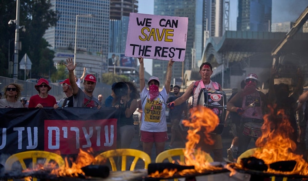 Demonstrators block a highway and burn an installation of a Shabbat dinner table demanding the immediate release of captives, calling for the Israeli government to reverse its decision to take over Gaza City, in Tel Aviv, Aug. 22, 2025. (AP)
