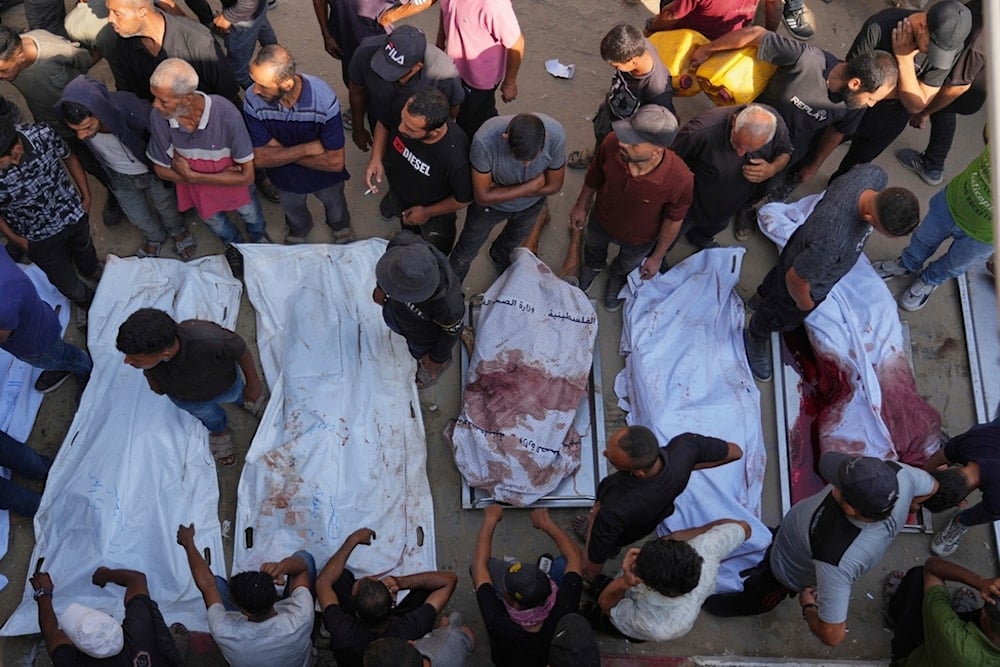 Palestinians mourn over the bodies of people killed either by Israeli military strikes or while trying to reach aid trucks, outside Shifa Hospital, in Gaza City, Occupied Palestine, Thursday, Aug. 21, 2025 (AP)