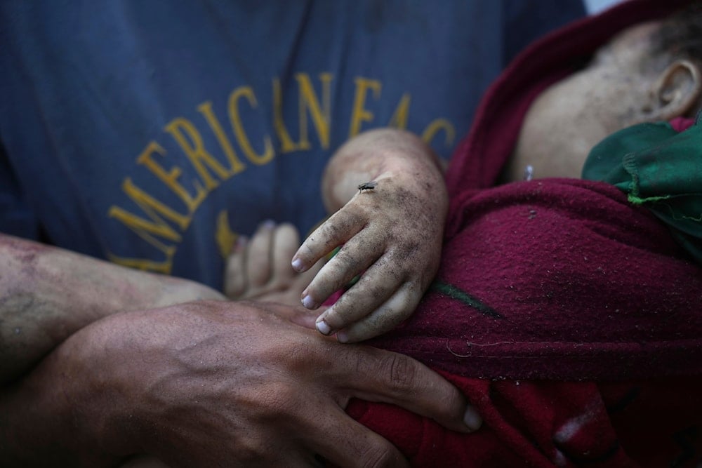 Alaa Hassanein carries the body of his 4-year-old niece, Sara Hassanein, who was killed in an Israeli military strike on a school used as a shelter, outside Al-Shifa Hospital, in Gaza City, on August 22, 2025. (AP Photo/Abdel Kareem Hana)