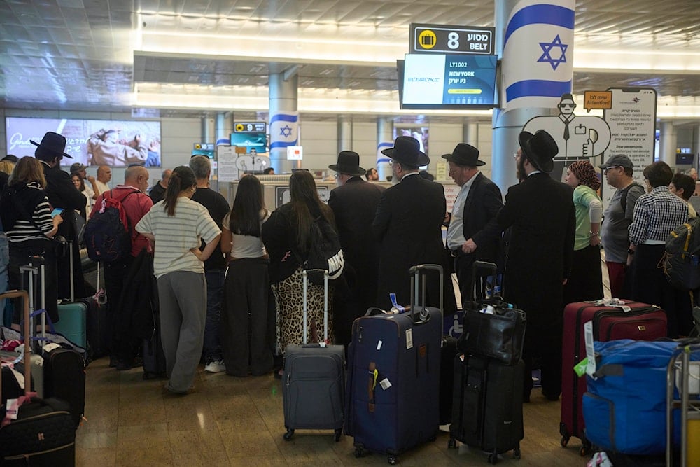 Travelers arrive at Ben Gurion Airport, a day after the announcement of a ceasefire between 