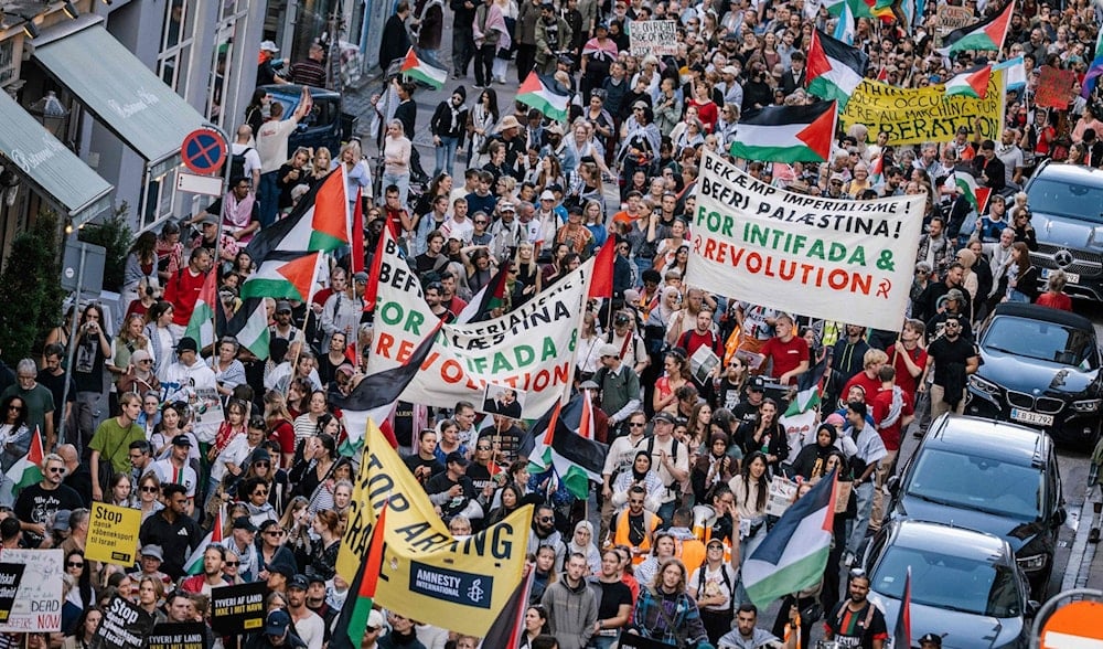Protesters march holding banners in support of Palestine in Copenhagen, Denmark, August 24, 2025 (Social Media)