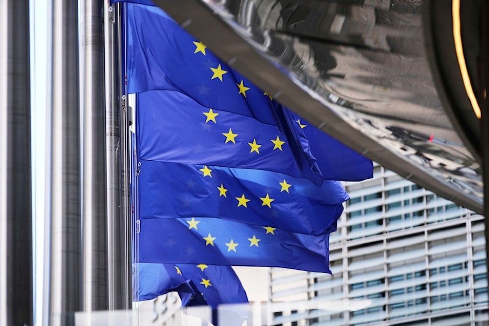 European Union flags flap in the wind outside EU headquarters in Brussels, Thursday, Aug. 21, 2025. (AP Photo/Virginia Mayo)