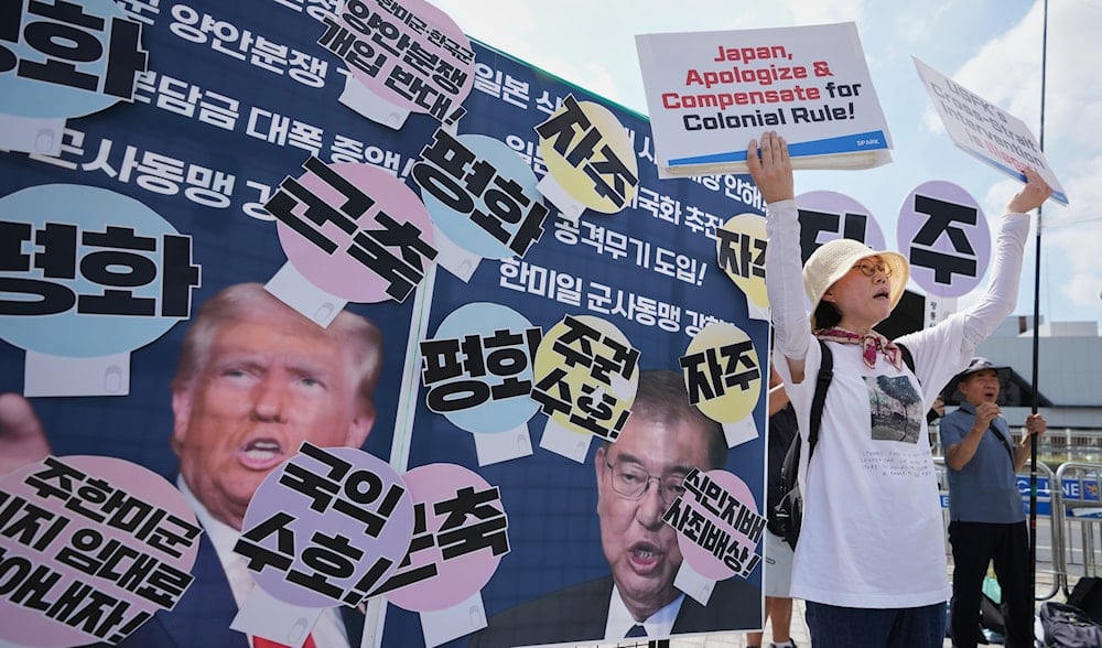 Members of civic group shout slogans next to pictures of US President Donald Trump and Japanese Prime Minister Shigeru Ishiba during a rally ahead of South Korean President Lee Jae Myung's visit to Japan in Seoul, South Korea, Aug. 22, 2025. (AP)