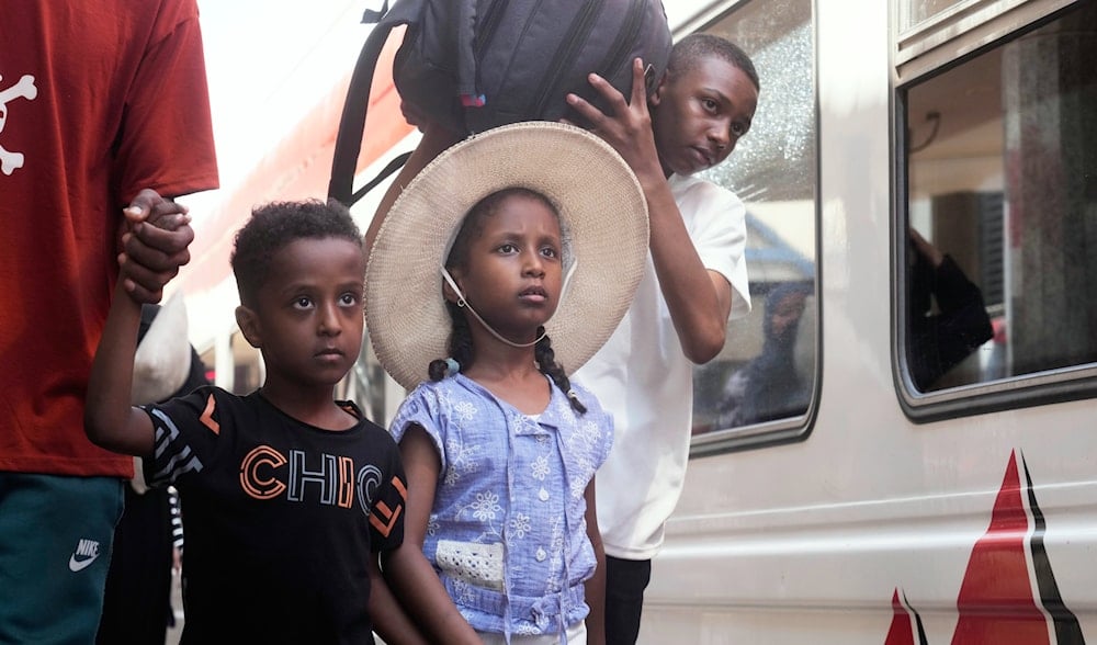 A Sudanese family, who were driven from their homes and are now returning, wait for their train to Aswan at Cairo's Ramses railway station, Egypt, Monday, July 21, 2025. (AP)
