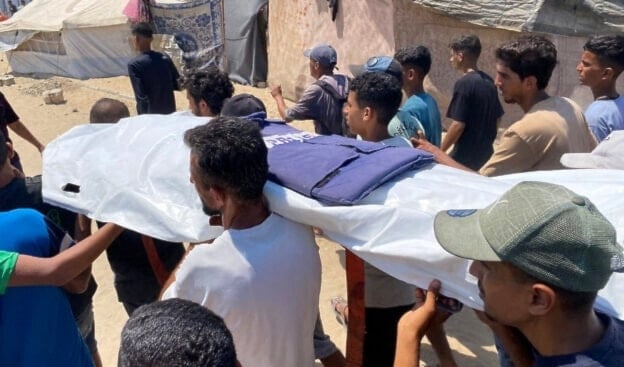 Mourners carry the body of one of five journalists killed in an Israeli strike on Nasser hospital in Khan Younis in the southern Gaza Strip, during their funeral on August 25, 2025. (AFP)