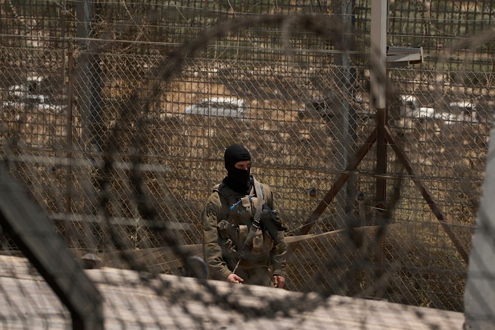 An Israeli soldier stands guard at the Israeli-controlled Golan Heights town of Majdal Shams, Thursday, July 17, 2025. (AP Photo/Leo Correa)