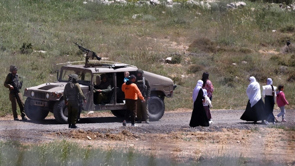 Israeli soldiers stop a Syrian Druze family, who fled sectarian violence outside Damascus, from crossing the buffer zone that used to separate Israeli and Syrian forces on Golan Heights. Photo undated (Jalaa MAREY/AFP)