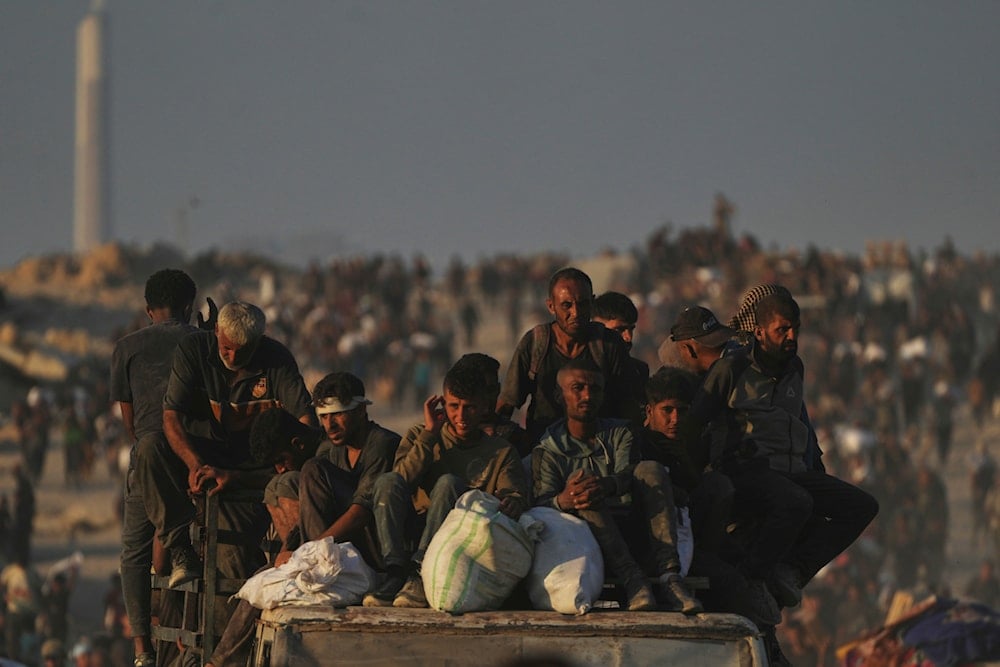 Palestinians carry sacks of flour unloaded from a humanitarian aid convoy that reached Gaza City from the northern Gaza Strip, on August 24, 2025. (AP Photo/Abdel Kareem Hana)