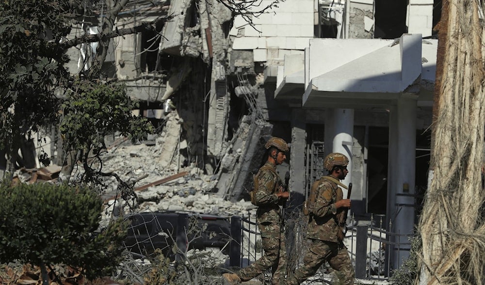 Syrian soldiers walks in front of the Syrian Defense Ministry building, which was heavily damaged by Israeli airstrikes, in Damascus, Syria, Saturday, July 19, 2025. (AP)