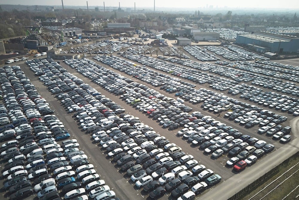 New German cars are stored at a logistic center in Essen, Germany, Thursday, March 27, 2025. (AP Photo/Martin Meissner)