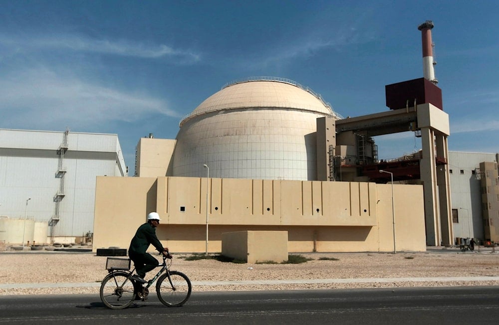 In this Oct. 26, 2010 file photo, a worker rides a bicycle in front of the reactor building of the Bushehr nuclear power plant, just outside the southern city of Bushehr (AP)
