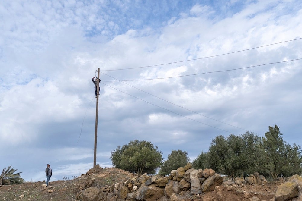 Workers fix an electricity grid in a Syrian village where the Israeli occupation forces made an incursion, in Rafid, on the outskirts of Quneitra, Syria, Sunday, January 5, 2025 (AP)