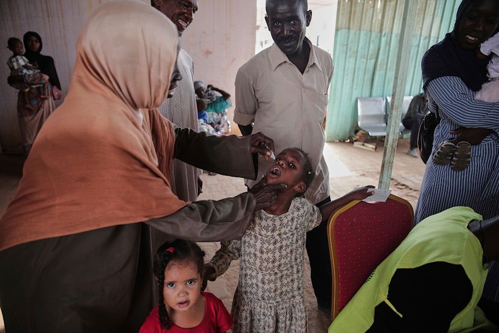 A health worker administers an oral cholera vaccine to a child during a 10-day vaccination campaign in Khartoum, Sudan, Wednesday, Aug. 13, 2025 (AP)
