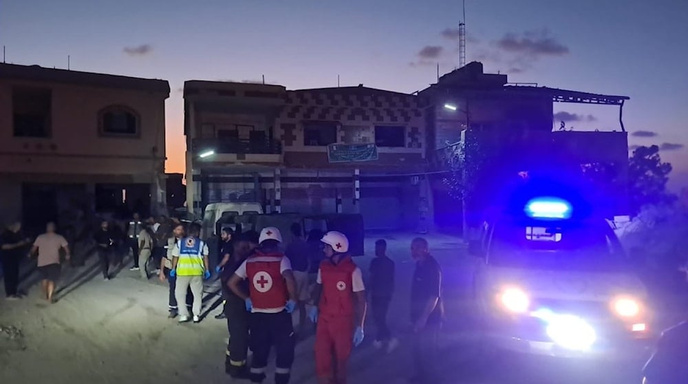 Emergency responders and residents gather at the site in Naqoura, southern Lebanon, after an Israeli drone explosion killed two Lebanese soldiers and injured another.
