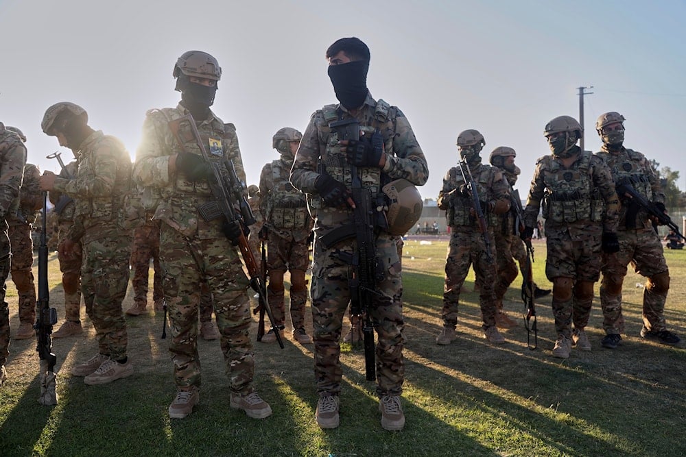 Fighters from the Syrian Democratic Forces (SDF) prepare to attend a military parade, in Qamishli, northeastern Syria, Tuesday, Aug. 12, 2025 (AP)
