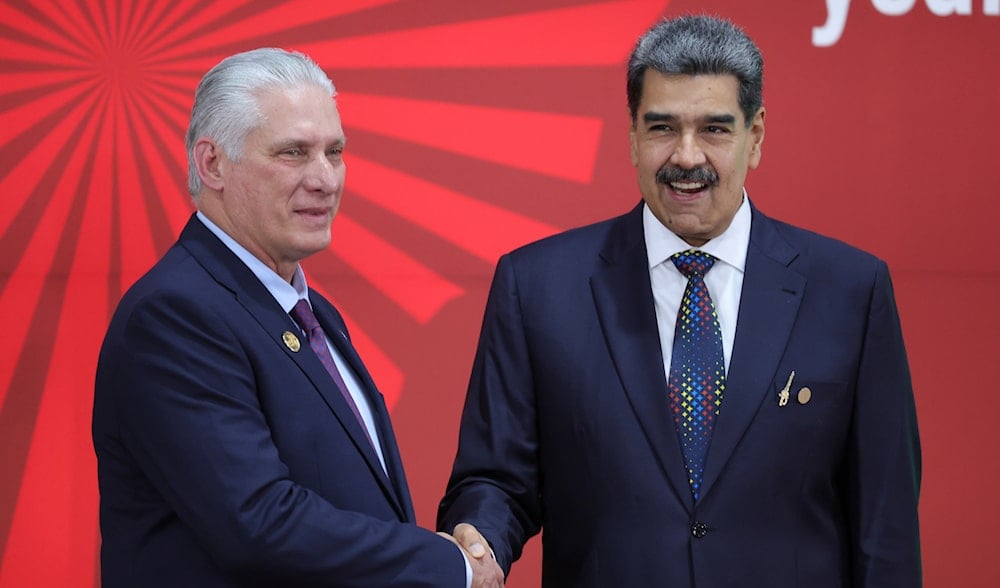 Cuba's President Miguel Diaz Canel, left, and Venezuelan President Nicolas Maduro shake hands as they pose for photos at the start of the Bolivarian Alliance for the Peoples of Our America Summit, in Caracas, Venezuela, Dec. 14, 2024. (AP)