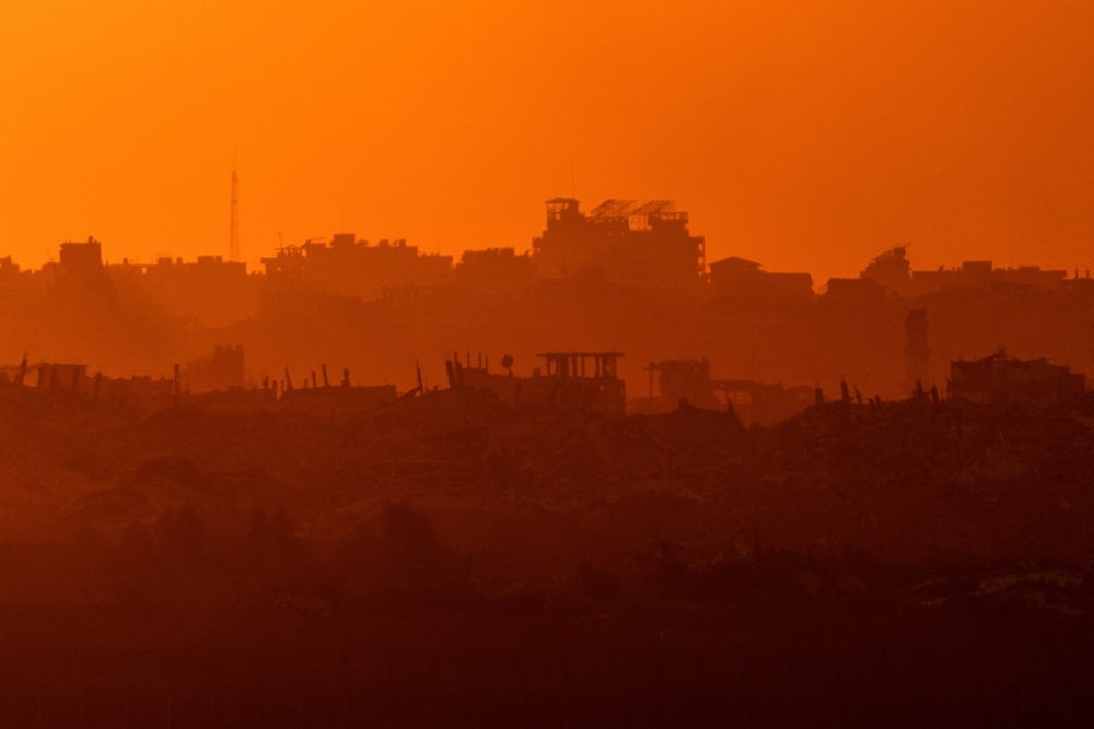 Buildings that were destroyed during the Israeli war on Gaza stand during the sunset as seen from Occupied Palestine, Friday, Aug. 29, 2025 (AP)