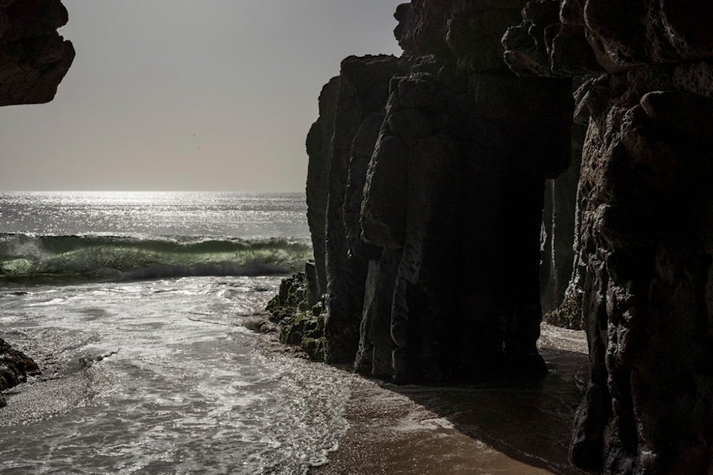 Waves from the Atlantic ocean break on a scared grotto, Thursday, Jan. 30, 2025. (AP Photo/Annika Hammerschlag)