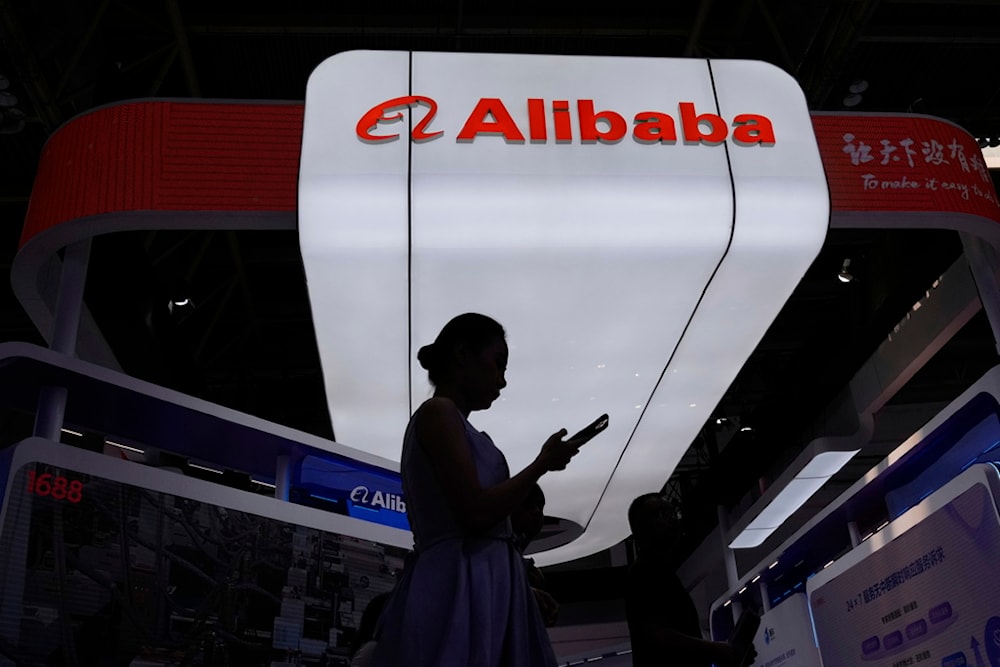 A visitor walks in front of Alibaba booth during the 3rd China International Supply Chain Expo at the China International Exhibition Center, in Beijing, China, Friday, July 18, 2025. (AP Photo/Mahesh Kumar A.)