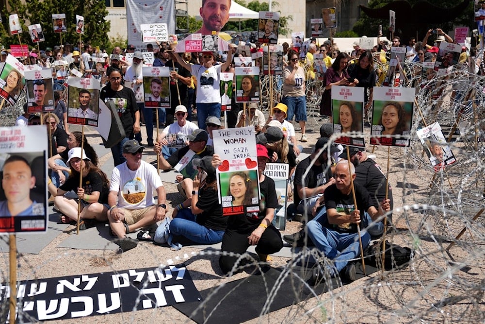 Families of captives protest, demanding the release from the Gaza Strip, at the plaza known as the Hostages Square in Tel Aviv, occupied Palestine, Saturday, Aug. 2, 2025 (AP)